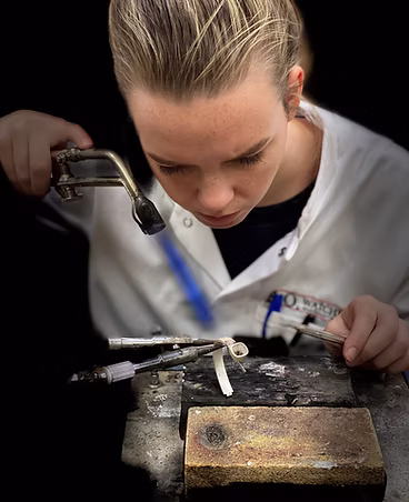 Veerle Oostwegel working on a piece of jewellery during her training